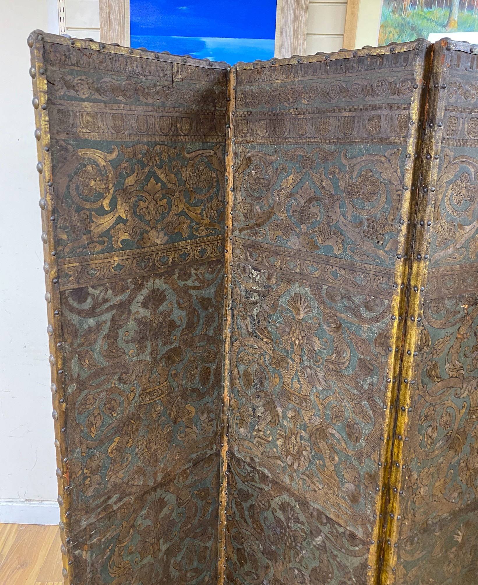 A 19th century French studded leather four fold screen, each panel width 49cm, height 182cm